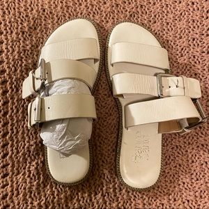 White sandals with straps and buckles